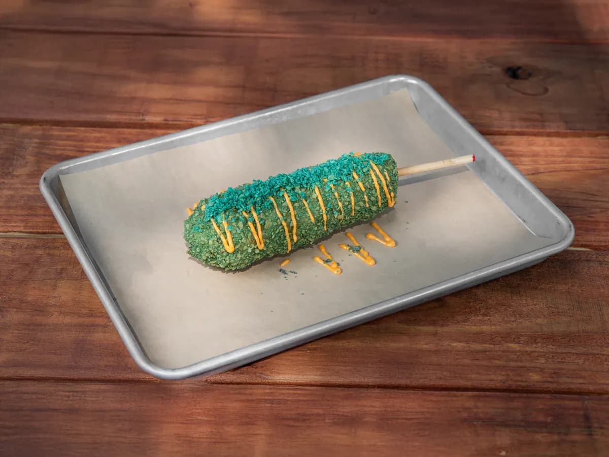 A Blue Takis K-Dog in an electric blue crust with spicy Seoul drizzle