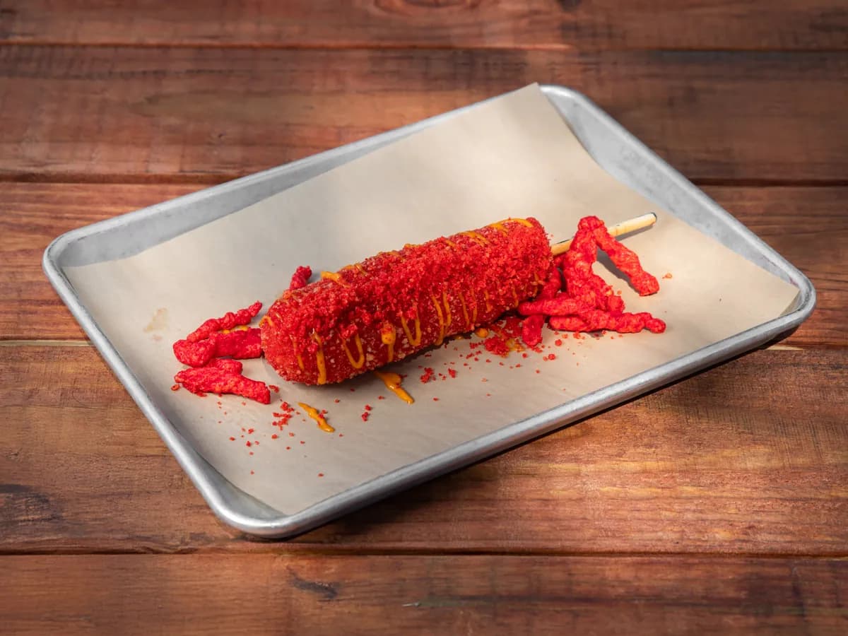 A Flamin' K-Dog in a red Cheetos crust with spicy Seoul drizzle