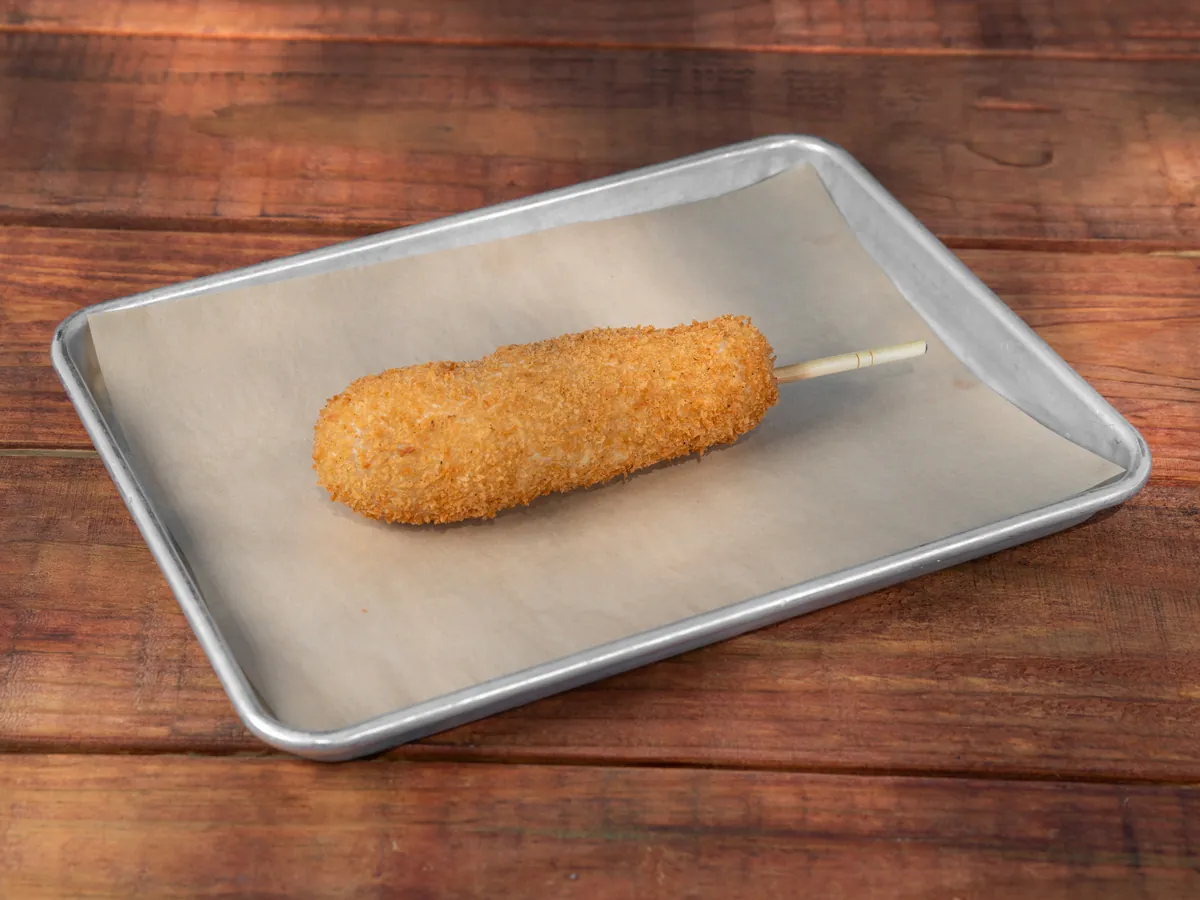 An OG K-Dog on a tray, panko crust fried deep gold