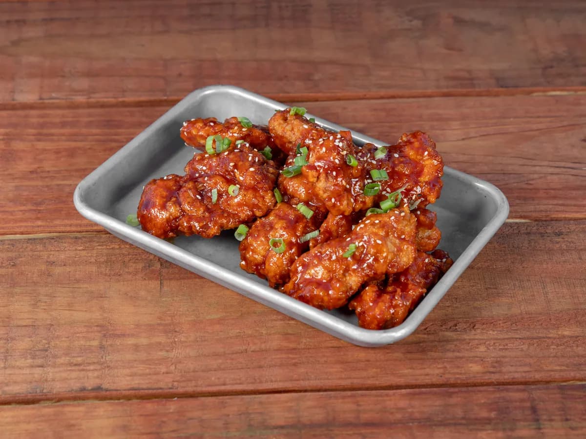 Korean fried chicken in Spicy Red sauce with sesame and scallion