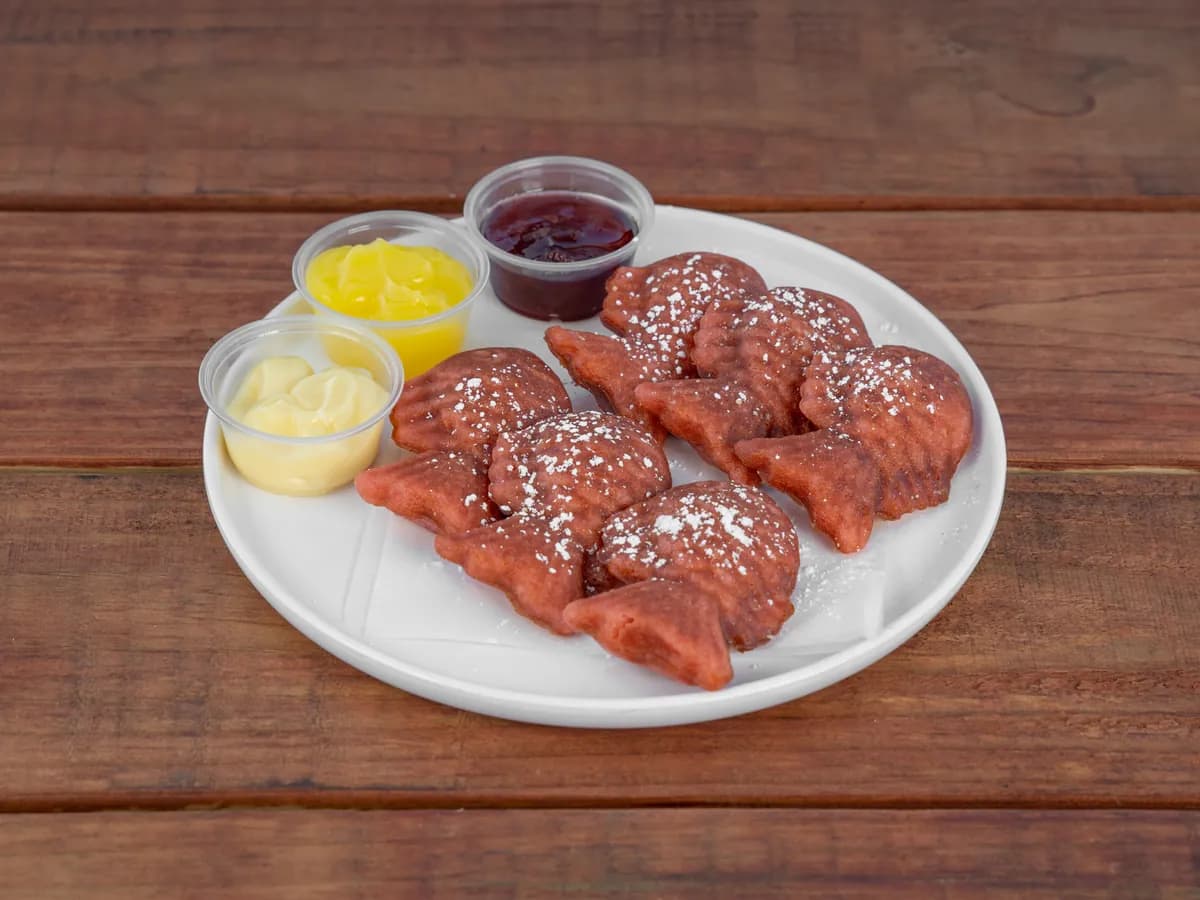 Pink fish-shaped mini waffles dusted with powdered sugar